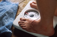 Feet on bathroom scale. Photo credit: Bill Branson