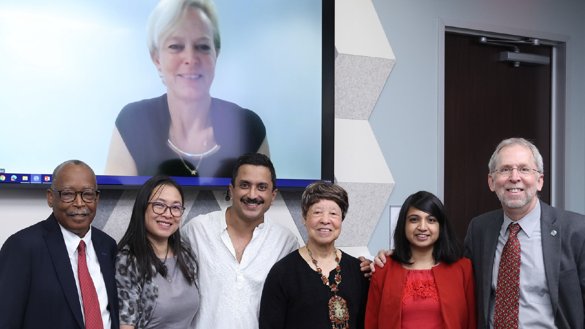 DEIA Awardees Group Photo (from left to right): Vence Bonham, Lucia Hindorff, Shurjo Sen, Bettie Graham, Shilpa Garg, Eric Green. On Screen: Nicola Mulder.