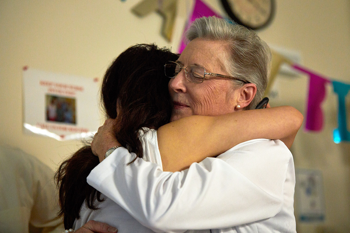 Cynthia Tifft and Lei embrace