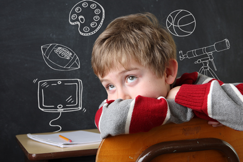 Young boy daydreaming in school