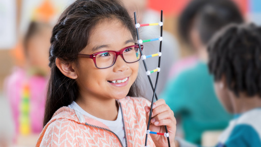 Little girl holding DNA model