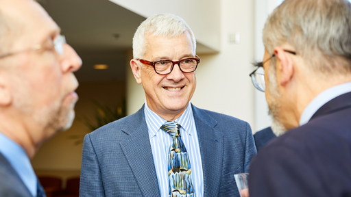 Leslie Biesecker chatting with his colleagues