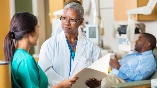 Physican and nurse discussing patient chart