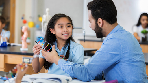 student and teacher talking over dna model