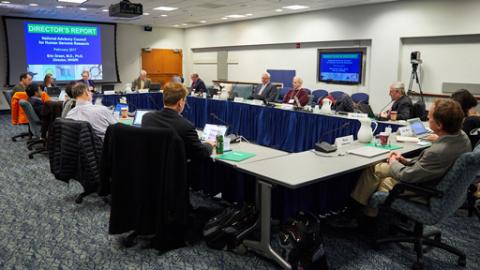 Staff around table at a meeting